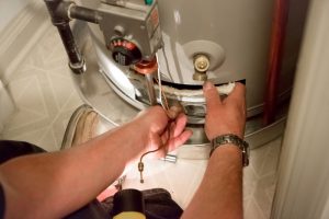 hot-water-heater-repair-service technician tightening valve