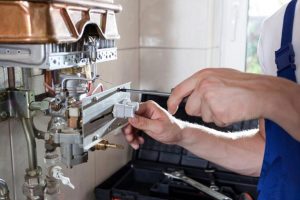 plumber-fixing-hot-water-heater cheap water heater fixer