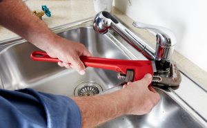 Picture of plumber fixing faucet