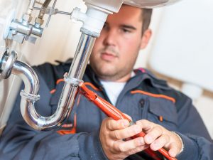 photo-of-a-plumber-tightening-pipe emergency plumber in southampton