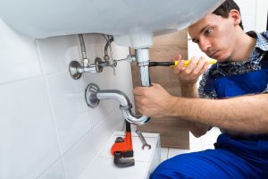 picture-of-a-plumber-fixing-drainage Picture of a professional plumber