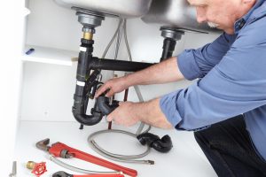 Picture of plumber fixing drain
