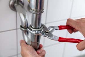 photo-of-a-professional-plumber-repairing-sink Emergency Plumber in Wichita, Kansas