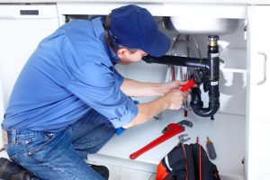 photo-of-a-professional-plumber-while-repairing-a-broken-drain photo of a professional plumber while repairing a broken drain