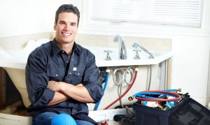 plumber-beside-a-bathtub-photo Emergency Plumber in Toledo, Ohio