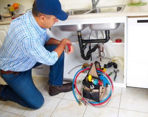 plumber photo fixing broken sink drain