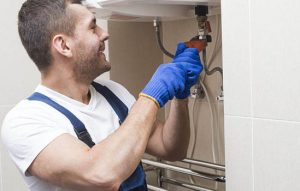professional plumber photo under the broken sink