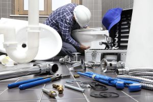 plumber-installing-toilet-bowl-photo plumber installing toilet bowl photo