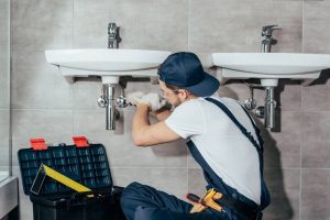 plumber installing bathroom sink photo