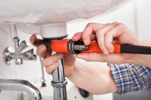 plumber-photo-while-using-a-wrench plumber photo while using a wrench